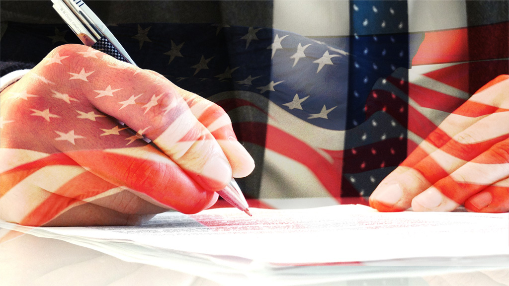 A man writing a legal form with an american flag overlaying